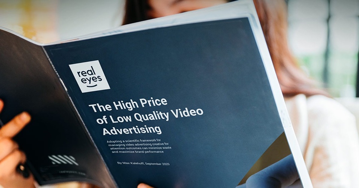 CMO reading a white paper 'The High Price of Low Quality Video Advertising'