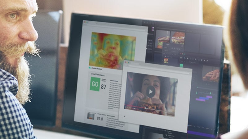 Two people working in front of a screen