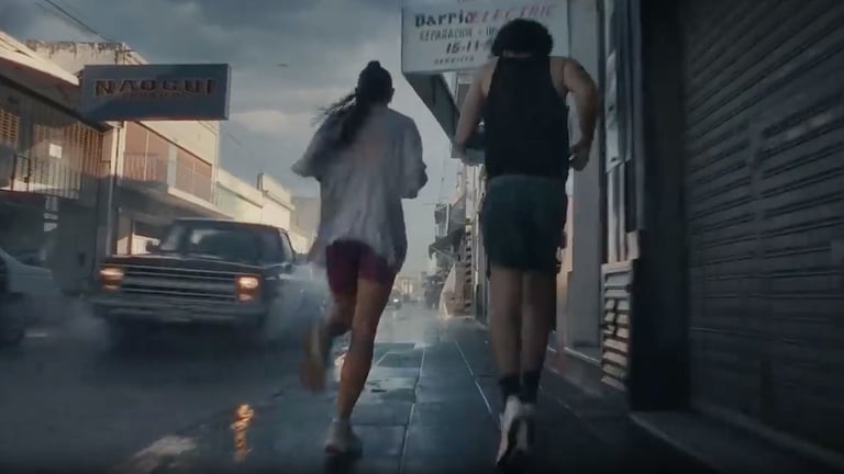 Two people running in wet weather